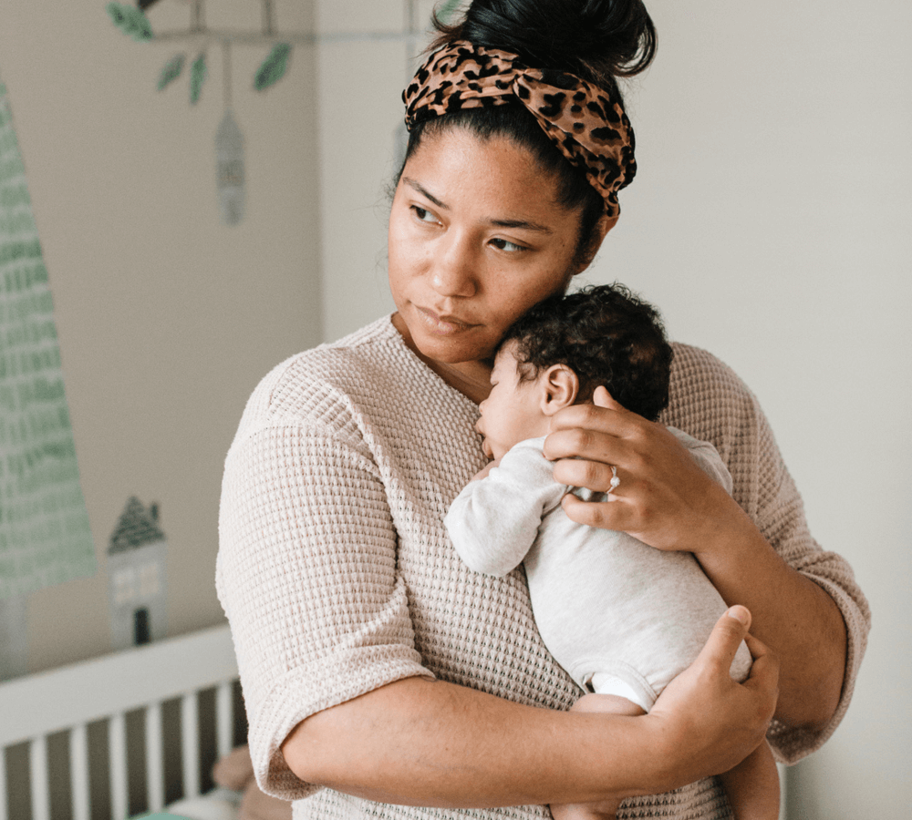 Woman holding a newborn baby. 